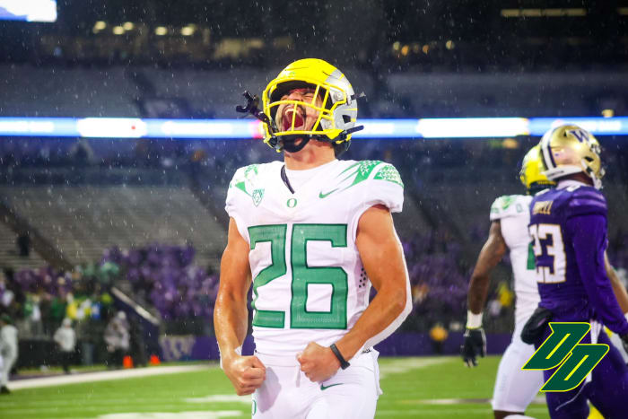 Travis Dye celebrates after a touchdown run against Washington.